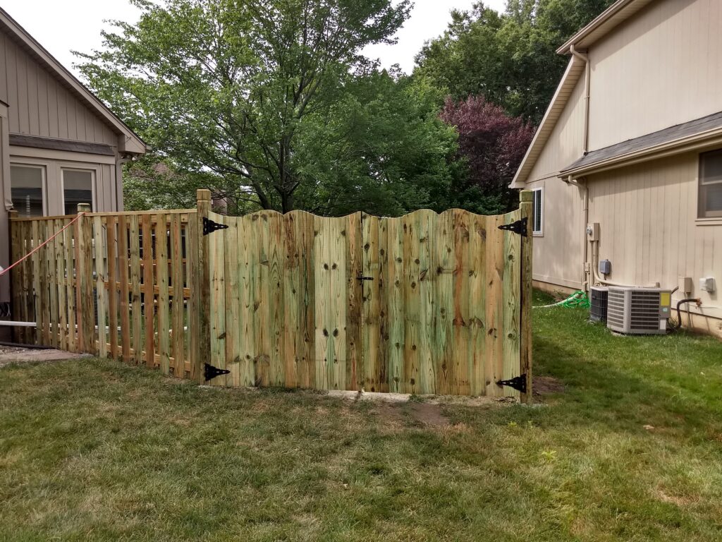Wooden fence with scalloped top